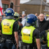 Essex Police bussing claims, Epping migrant hotel protest, counter-protest escort denial, unrest Bell Hotel Essex, Nigel Farage Essex Police controversy.